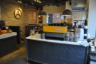 The espresso machines have a counter of their own to your right, with the seating beyond.