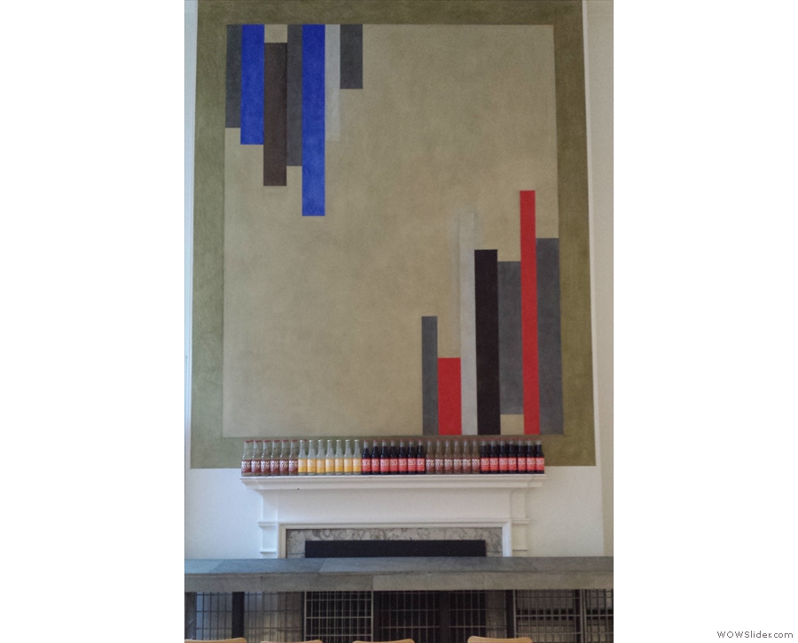 There is another fireplace, with more abstract art above it...