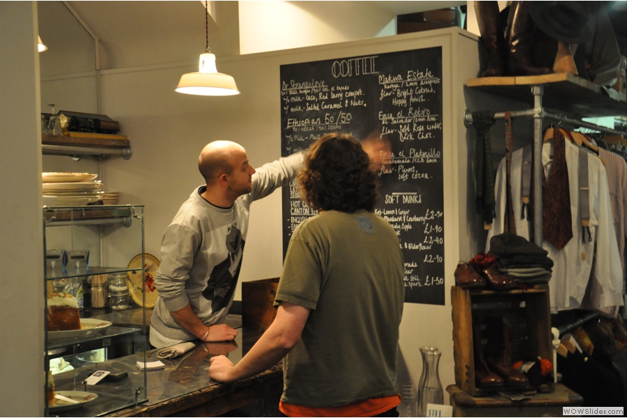 Kit comes out from his hiding place to explain the menu to Andrew. Or to wipe it off the blackboard. Not sure which...
