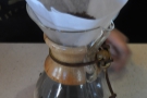 The Chemex is prepared, the beans ground, and then placed in the filter paper.