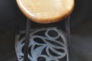 A similar motif continues on the base of the stools.