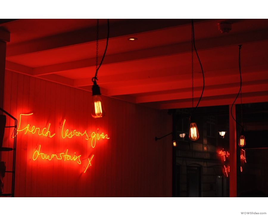 Light-bulbs and neon signs on the wall.