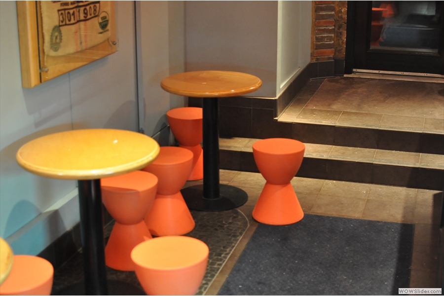 There's not much in the way of seating. These orange stools and round tables are at the front, opposite the cakes. There are three tables in all and that's where you will usually find me.