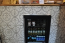 Detail of the beautiful tiling on the counter, plus the soft drinks fridge.
