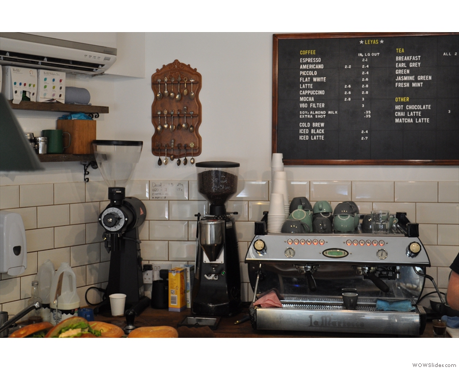 The coffee corner, with the menu on the wall behind the espresso machine.