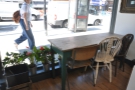 The window table, complete with pot-plants, is good for people watching on the busy street.