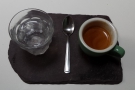 Espresso on a slate. With a glass of water, naturally.