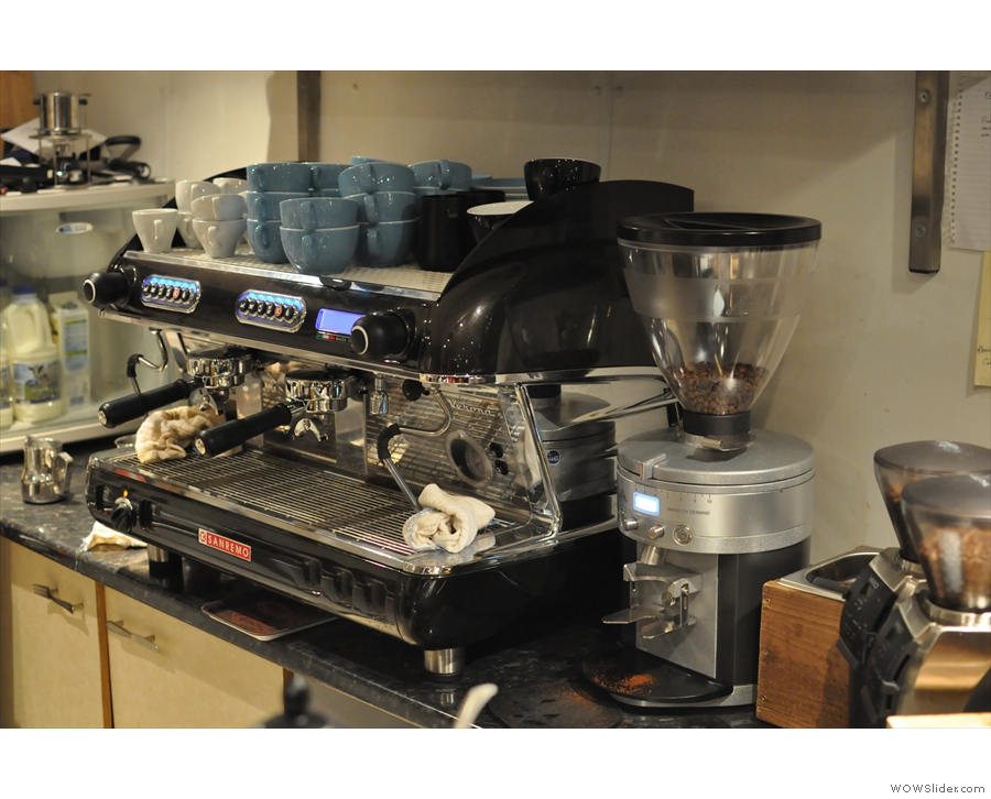 The espresso machine with a pleasing array of cups and a multitude of grinders. 