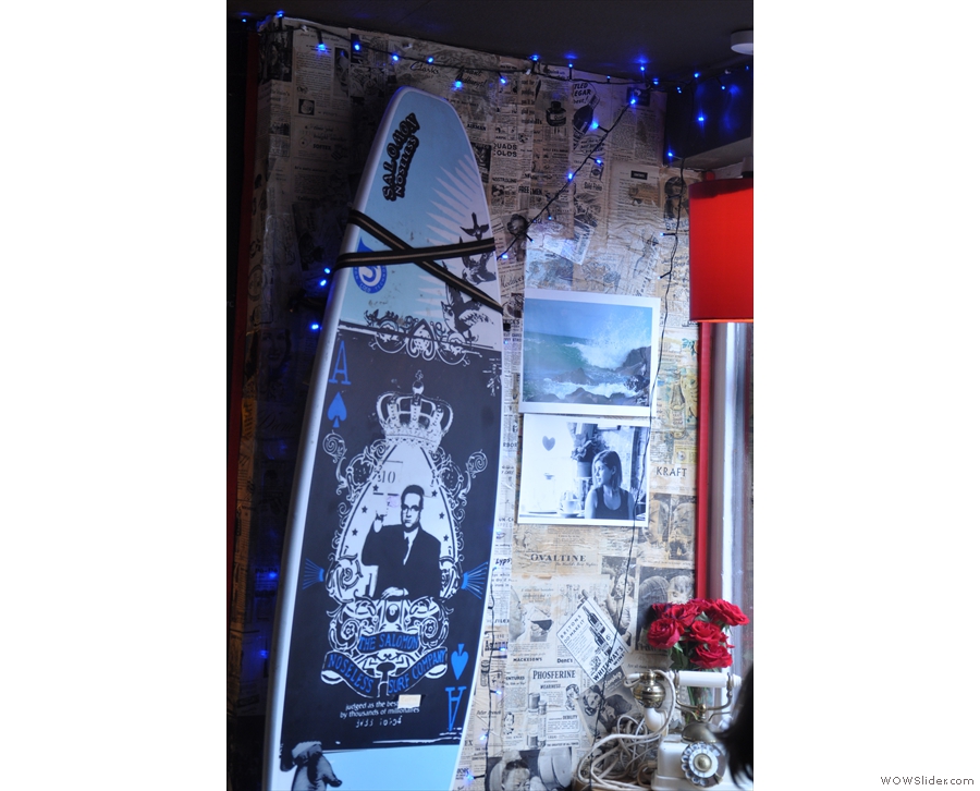 There's also this highly-decorated surf board strapped to the wall.
