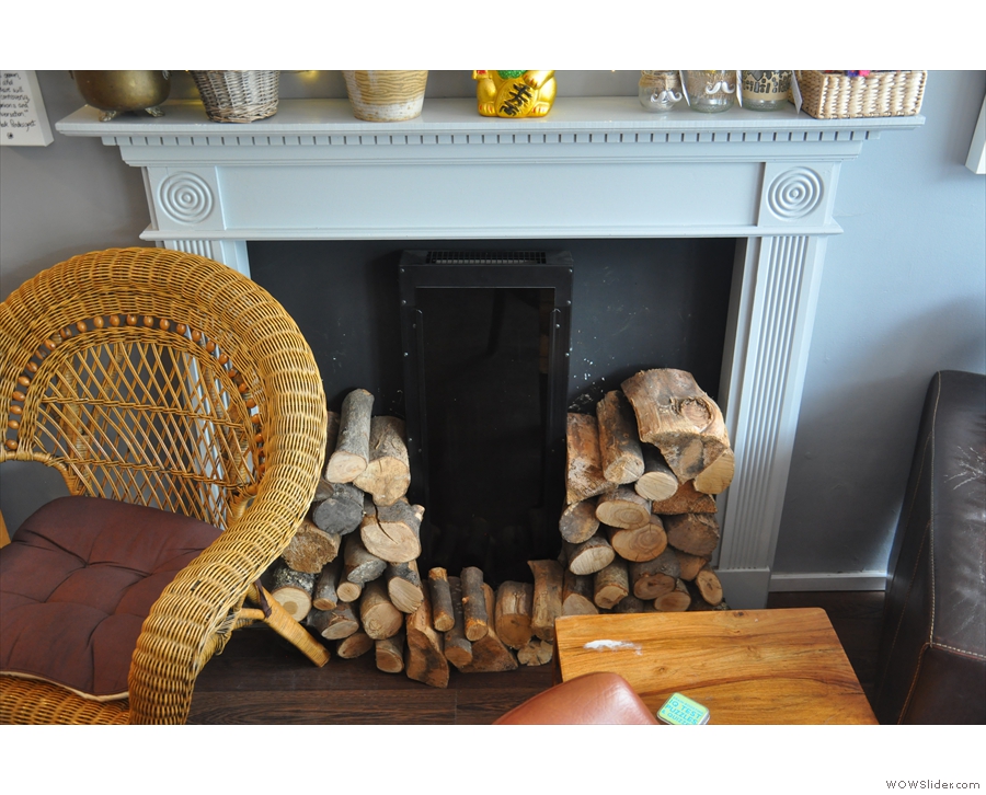 Neatly-stcked piles of wood suggest that this is a real, working fireplace.