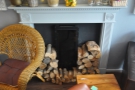 Neatly-stcked piles of wood suggest that this is a real, working fireplace.