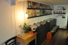 The vinyl part of Baila Coffee & Vinyl is opposite the counter on the left-hand side.