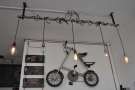 Naturally, there's a folding bike hanging on the wall behind the counter...