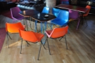 There are these tables, with their mult-coloured bucket-seat chairs (like those outside)...