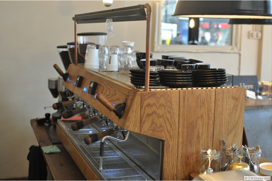 Another view of the espresso machine, tastefully clad in wood.