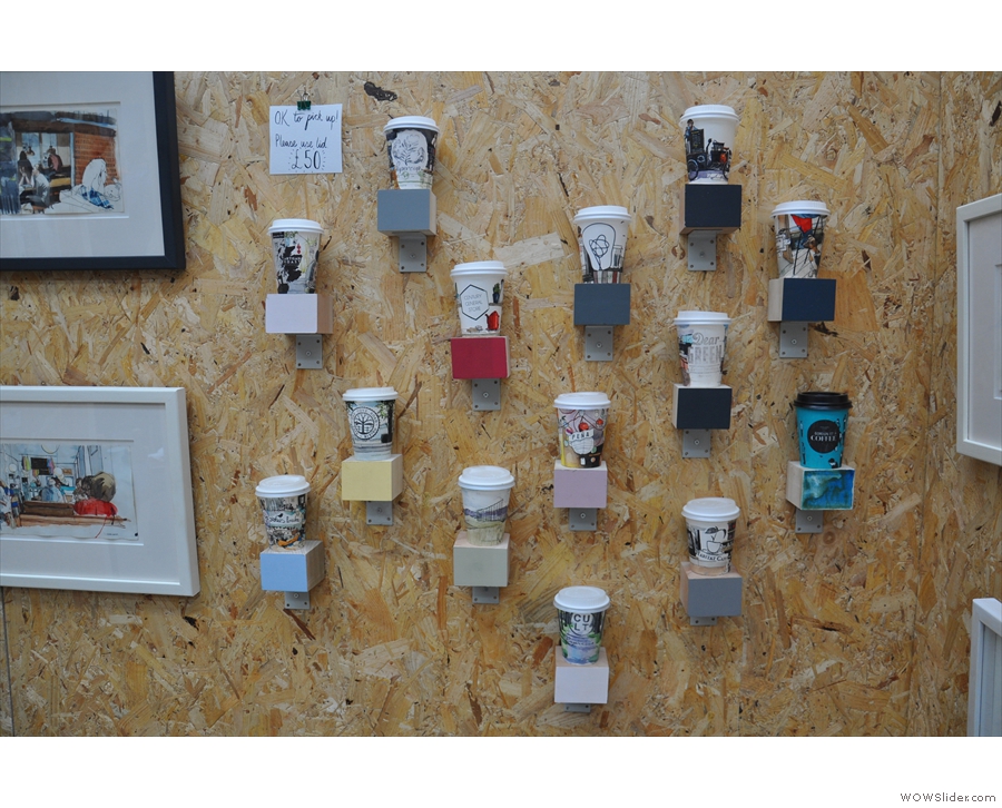 ... while on the back wall, hand-illustrated takeaway coffee cups.