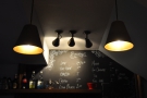 The menu's chalked up on the wall behind the counter. Moody.
