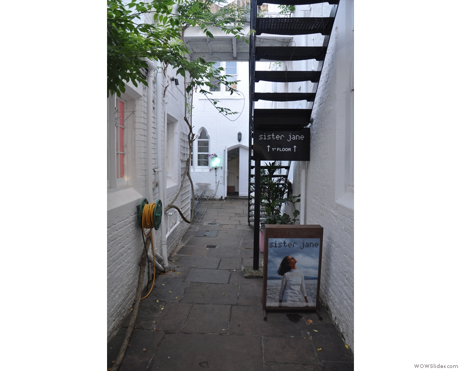 Follow the arrows down this long, narrow passage and past the stairs to Sister Jane...