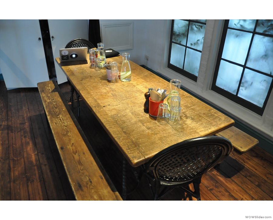 This communal table dominates the space. You can book it if you have group.