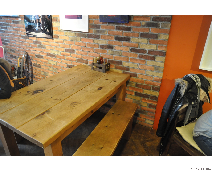 This communal table, complete with benches, is opposite the counter...