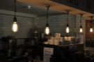 The counter has more traditional light bulbs hanging above it.