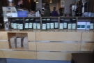 The retail section runs along the front of the counter, in the shape of bags of coffee for sale.