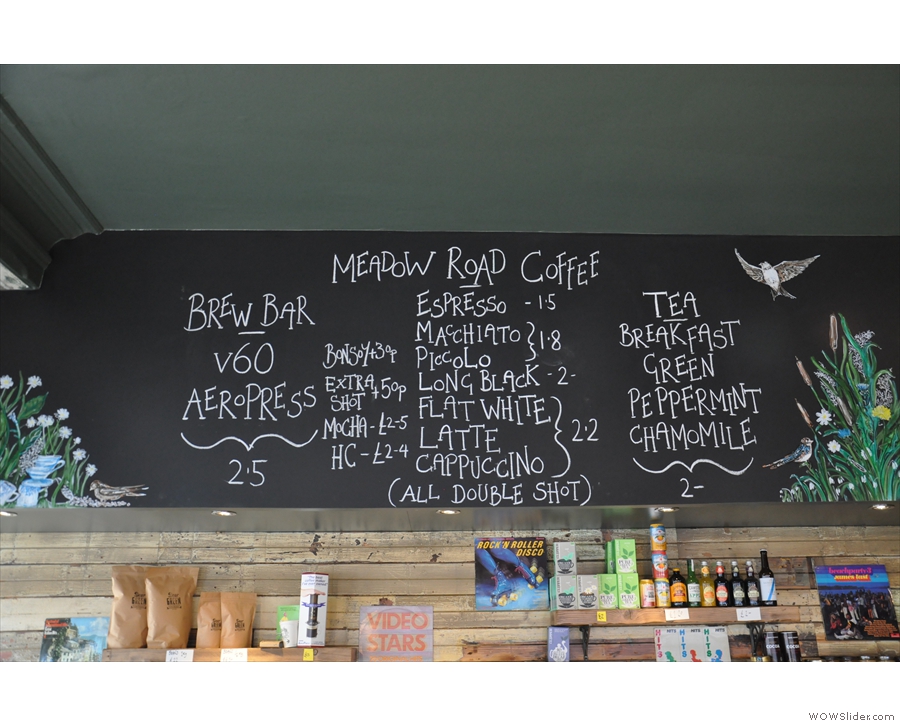 The hot drinks menu, plus artwork, is chalked up above the counter...