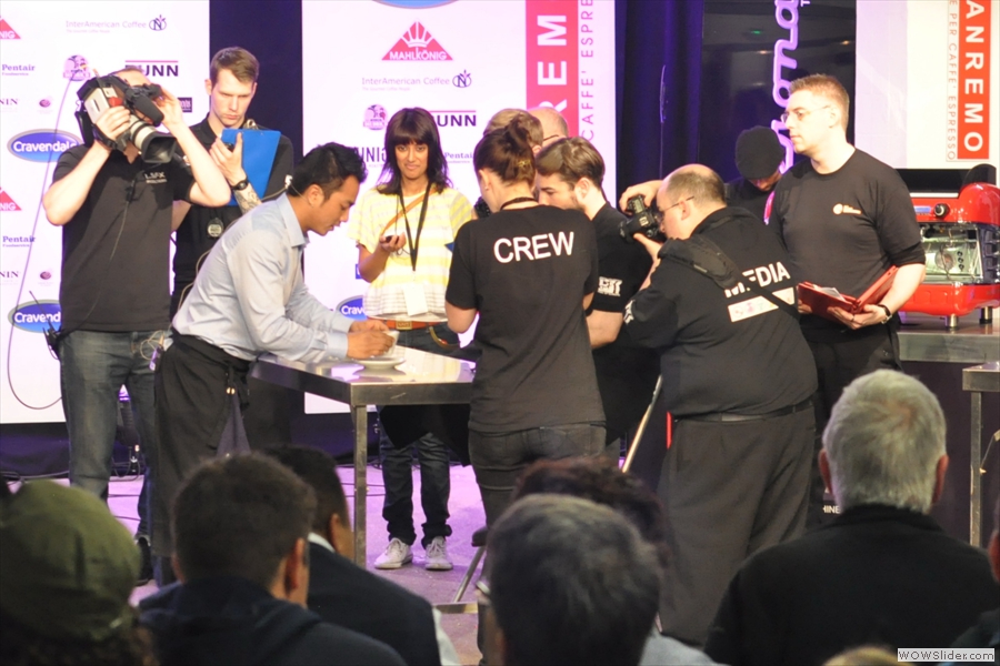 Dhan presents the latte to the judges. The time-keeper (each contestant has six miuntes) looks impressed!