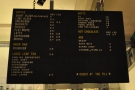 The coffee and soft-drinks menu hangs above the counter...