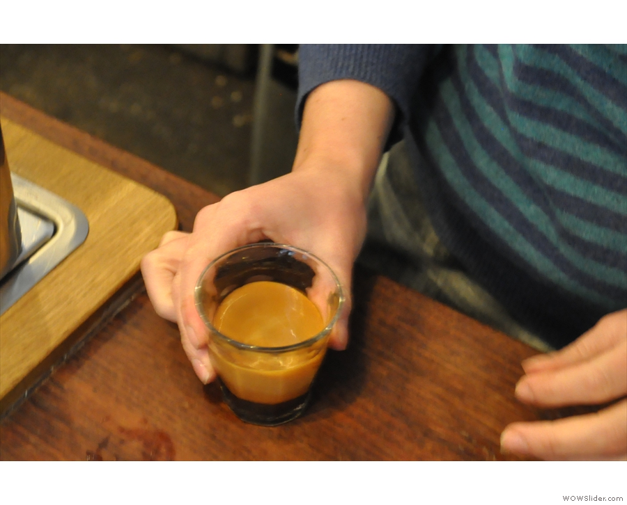 ... and then the barista springs into action, making a cortado for another customer.