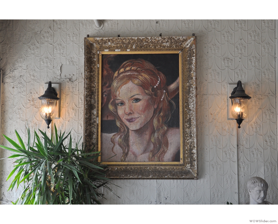 This fascinating portrait hangs above the comfy seating to the left as you come in.