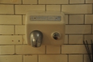 Yes, that is a hand-drier on the wall. Probably not a Victorian original though...