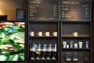 The actual coffee menu is on the wall to the right, along with the retail shelves.